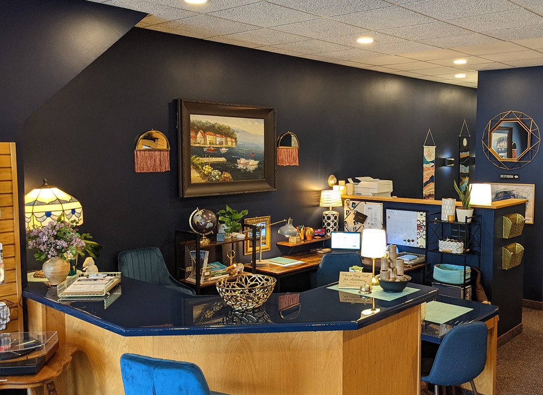 Red Wing, MN - Interior View of the Red Wing Office of Synergy Insurance Group Featuring a Navy Blue and Honey Wood Color Theme Office Setup